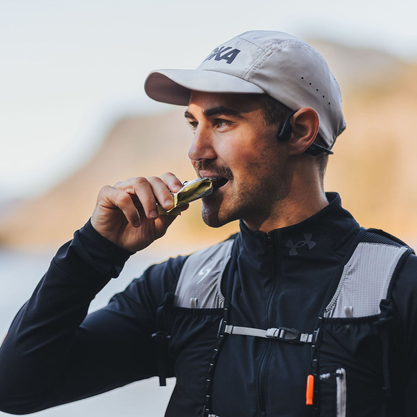 Runner eating a Krono Nutrition raspberry and lemon energy bar, outdoors