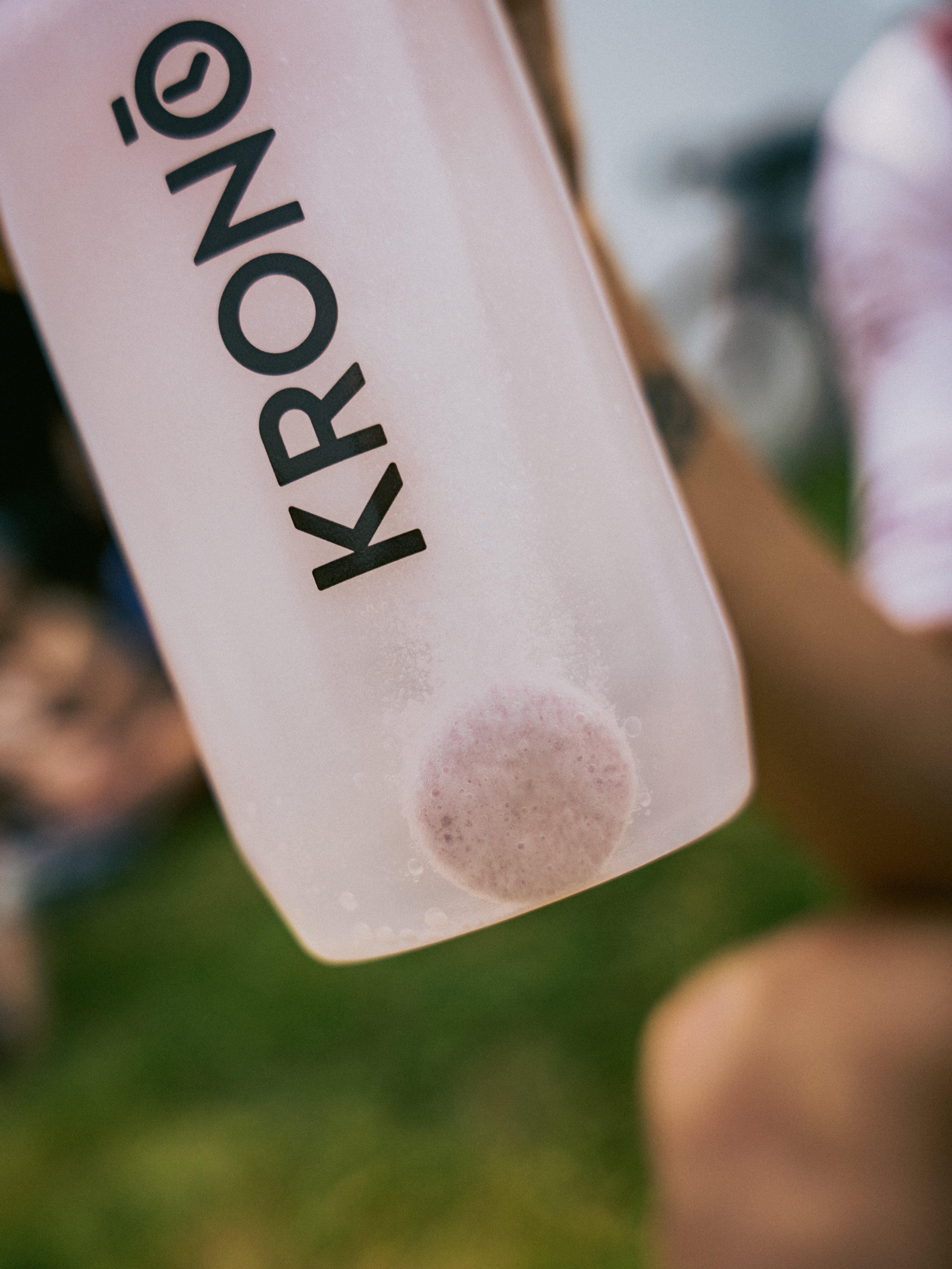 Krono water bottle held by a person outdoors