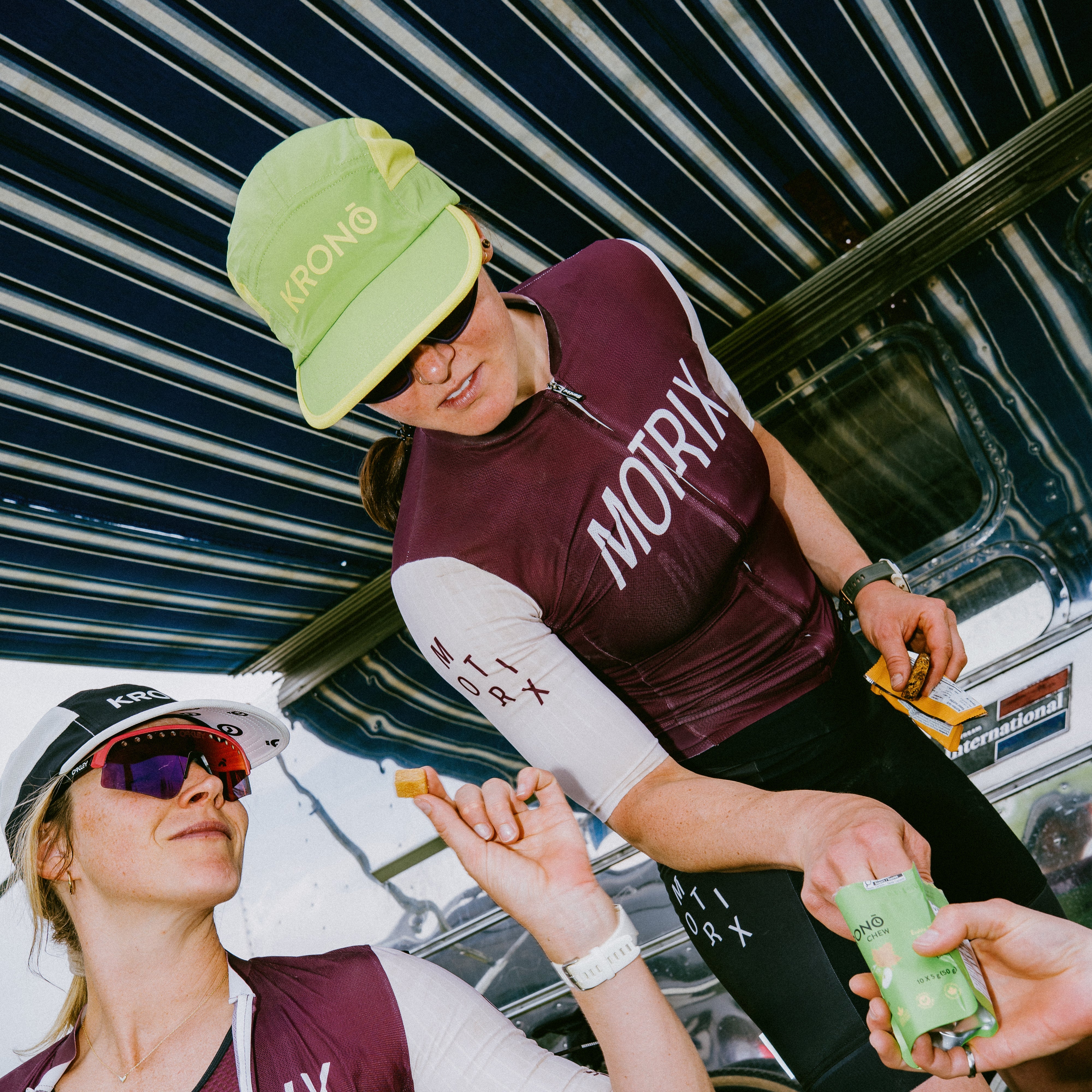 Cyclist wearing Krono Nutrition lemon and lime cap, while eating Krono Nutrition bars and chews