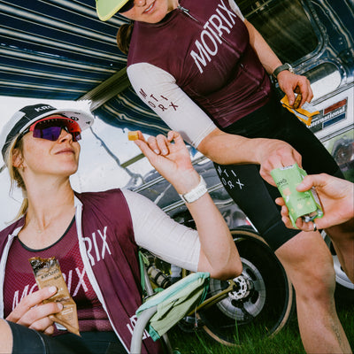 Cyclists taking a break to eat Krono Nutrition maple and apple energetic chews and Krono bars