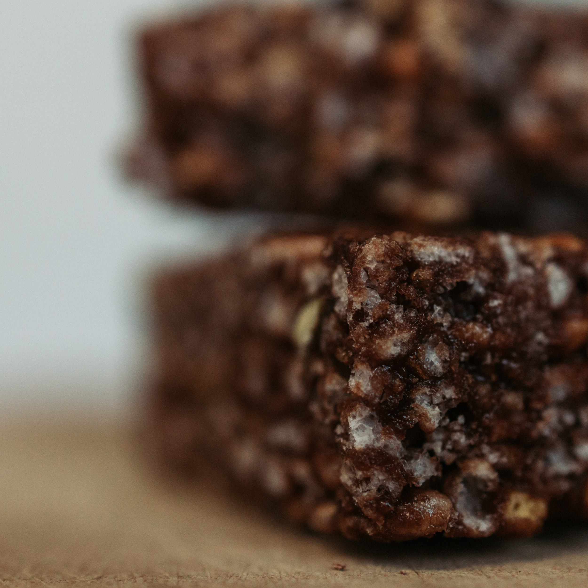 Close-up of a Krono Nutrition pretzel and chocolate energy rice cake in two pieces, with a blurry background